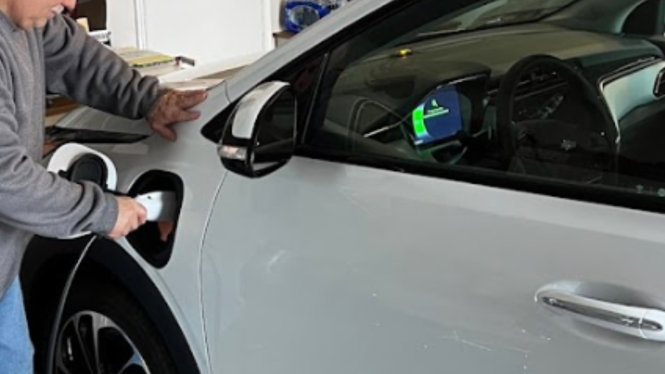 a driver is charging his EV at home