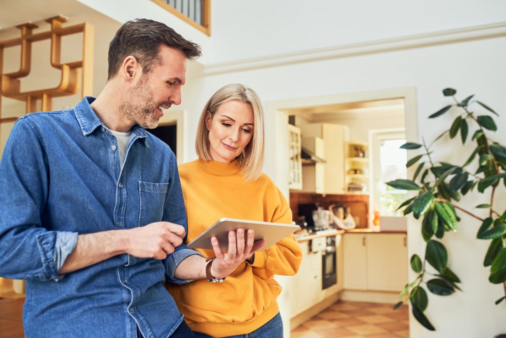 A young couple going over the spring electrical safety checklist for their home.
