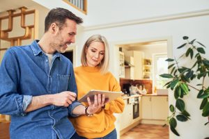 A young couple going over the spring electrical safety checklist for their home.