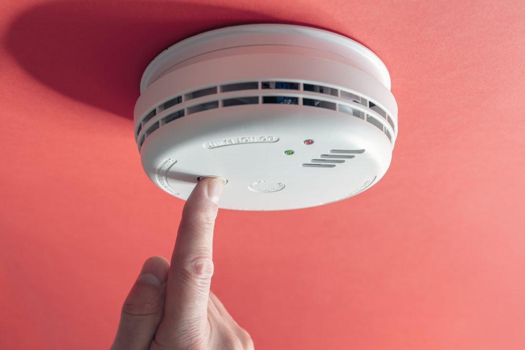 An Illinois homeowner tests their smoke detector. 