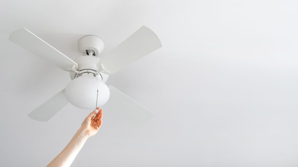 A Chicago homeowner turns on the ceiling fan to move the air in their home. 