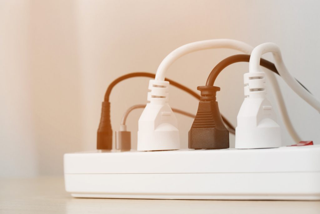A power strip with multiple cords plugged in.
