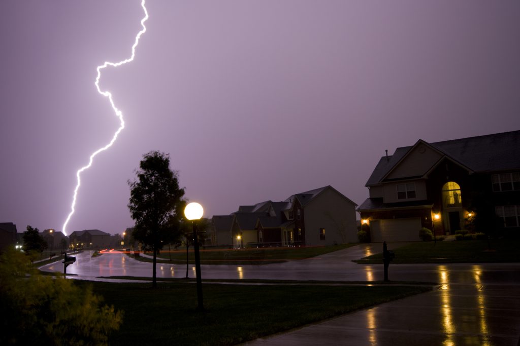 A thunderstorm in the sky over an Illinois suburb representing fall storms.