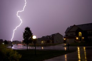 A thunderstorm in the sky over an Illinois suburb representing fall storms.